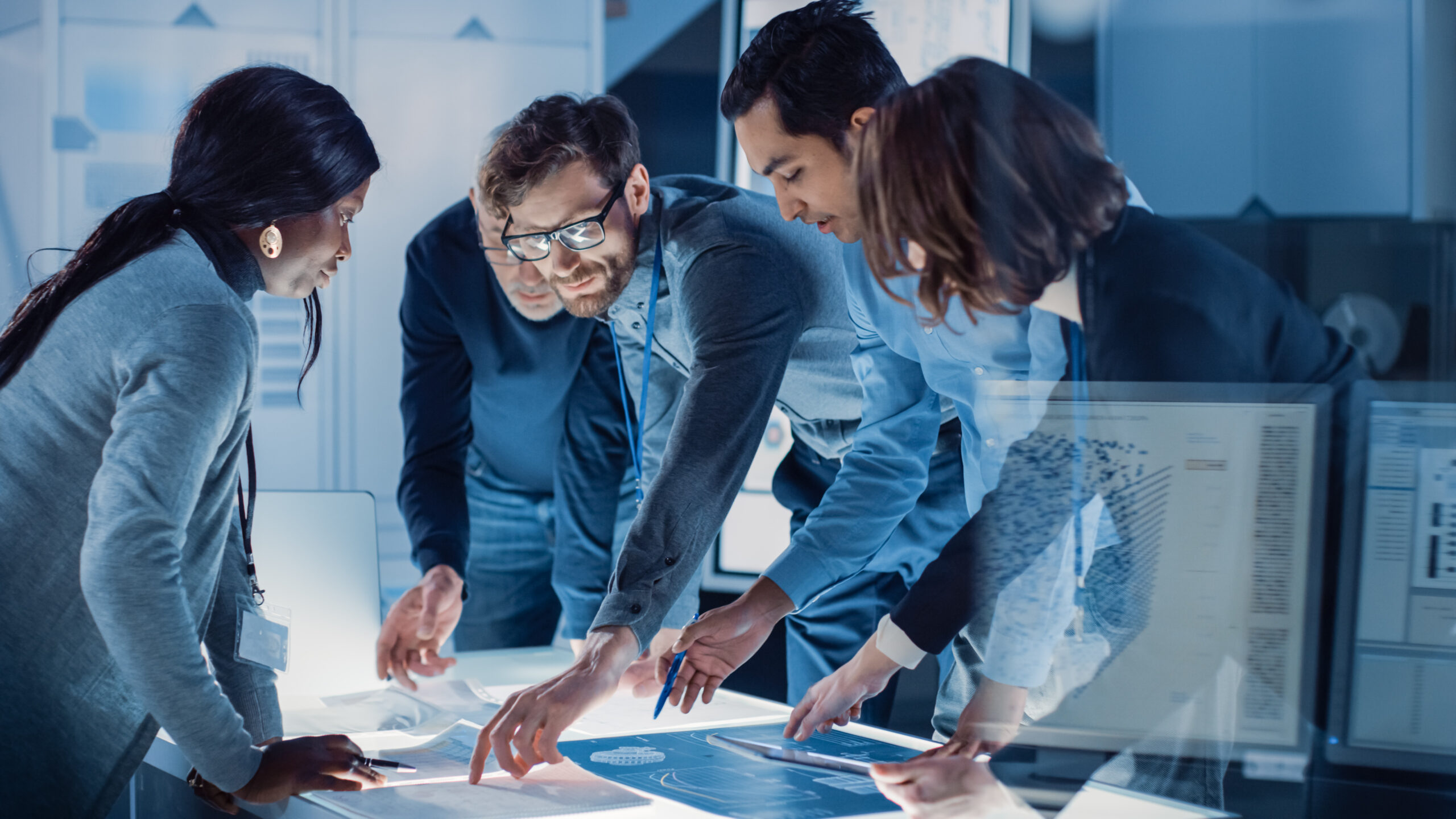 Executives collaborating around a digital strategy table during a leadership planning session.